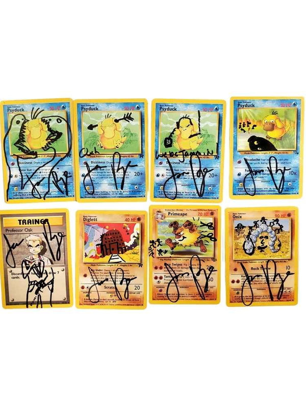 Set of eight autographed trading cards on a white background