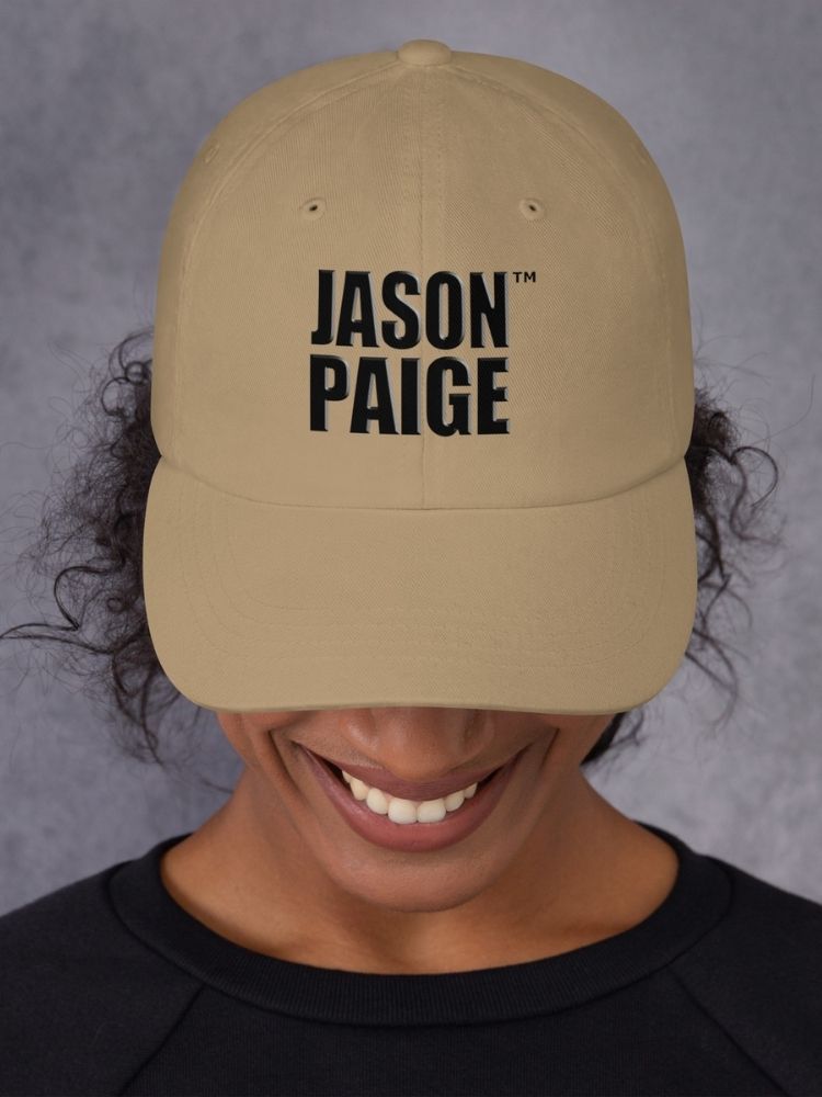 Person wearing a beige cap with 'JASON PAIGE' text on a gray background
